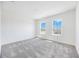 Spacious bedroom featuring windows, light grey carpet, and two large windows at 172 Eagleston Ln, Sarasota, FL 34240
