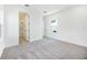 Bright bedroom with a walk in bath, light grey carpet, and natural lighting at 172 Eagleston Ln, Sarasota, FL 34240