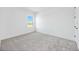 Bright bedroom with a window view of the outside, white walls, and light grey carpet at 172 Eagleston Ln, Sarasota, FL 34240