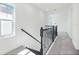 Upstairs hallway with a stair railing, bright light, and plush carpeting at 172 Eagleston Ln, Sarasota, FL 34240