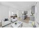Open-concept living space with neutral furniture, connecting living, dining, and kitchen areas at 172 Eagleston Ln, Sarasota, FL 34240