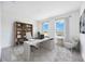 Bright home office with a large desk, built-in bookshelf, and two windows offering scenic views at 172 Eagleston Ln, Sarasota, FL 34240