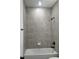 Contemporary bathroom boasts a modern tub and tiled walls at 19575 Fort King Run, Brooksville, FL 34601