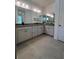 Elegant bathroom featuring double vanity, expansive mirror, and tiled floor, with a view into the shower at 19575 Fort King Run, Brooksville, FL 34601