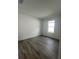 Cozy bedroom with a window and light colored wood flooring at 19575 Fort King Run, Brooksville, FL 34601