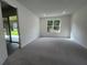 Large bedroom with neutral carpet and sliding glass door to the lanai at 19575 Fort King Run, Brooksville, FL 34601