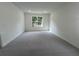 Spacious bedroom with a large window and neutral carpet at 19575 Fort King Run, Brooksville, FL 34601