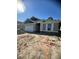 A lovely one-story home with a two-car garage and stone veneer accents, under a clear blue sky at 19575 Fort King Run, Brooksville, FL 34601