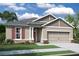 Charming single-story home boasts a two-car garage, manicured lawn, and inviting curb appeal at 19575 Fort King Run, Brooksville, FL 34601