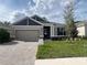 Beautiful single-story home with a brick paver driveway and manicured lawn at 19575 Fort King Run, Brooksville, FL 34601