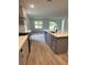 Open-concept kitchen offers stainless steel appliances and views into the living room at 19575 Fort King Run, Brooksville, FL 34601