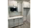 A cozy nook with upper and lower cabinets, stainless steel microwave, and white countertops at 19575 Fort King Run, Brooksville, FL 34601