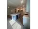 Modern kitchen with stainless steel appliances, large island, and sleek countertops at 19575 Fort King Run, Brooksville, FL 34601