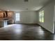 Bright open-concept living room with wood flooring and large windows at 19575 Fort King Run, Brooksville, FL 34601