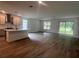 Spacious open-concept living room featuring wood flooring, plenty of natural light and an eat-in kitchen at 19575 Fort King Run, Brooksville, FL 34601