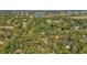 Aerial view of a tree-lined community featuring lush landscapes and waterway access at 2072 Misty Sunrise Trl, Sarasota, FL 34240