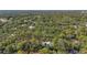 An aerial view showing a community nestled among mature trees and lush foliage at 2072 Misty Sunrise Trl, Sarasota, FL 34240