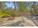 Backyard with stone floors, fence, greenery, and a brick fire pit with crushed gravel at 2072 Misty Sunrise Trl, Sarasota, FL 34240