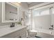 Bathroom with white tile, black fixtures and accents, and lots of natural light at 2072 Misty Sunrise Trl, Sarasota, FL 34240