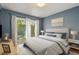Bedroom with neutral walls, a large window, and white curtains allowing lots of natural light at 2072 Misty Sunrise Trl, Sarasota, FL 34240