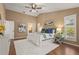 Bedroom featuring high ceilings, ceiling fan, wood floors, and bright, natural light at 2072 Misty Sunrise Trl, Sarasota, FL 34240