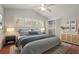Bedroom with vaulted ceiling, walk-in closet and lots of natural light from the large window at 2072 Misty Sunrise Trl, Sarasota, FL 34240