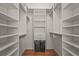 Walk-in closet with built-in shelving and hanging racks, plus two integrated laundry baskets at 2072 Misty Sunrise Trl, Sarasota, FL 34240