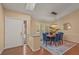 Bright dining area with stylish lighting, wood floors, and modern blue chairs at 2072 Misty Sunrise Trl, Sarasota, FL 34240