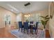 Bright dining room featuring a modern chandelier, natural light, and warm neutral paint at 2072 Misty Sunrise Trl, Sarasota, FL 34240