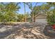 Charming home featuring a brick driveway and a well-manicured yard with mature trees and lush landscaping at 2072 Misty Sunrise Trl, Sarasota, FL 34240