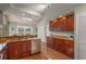 Kitchen featuring cherry cabinets, granite countertops, stainless steel appliances, and wood floors at 2072 Misty Sunrise Trl, Sarasota, FL 34240