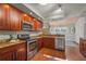 Well-equipped kitchen with wood cabinetry, stainless steel appliances, and granite countertops at 2072 Misty Sunrise Trl, Sarasota, FL 34240
