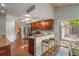 Bright kitchen features granite countertops, cherry cabinets, stainless appliances, and bar seating at 2072 Misty Sunrise Trl, Sarasota, FL 34240