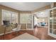 Office space adjacent to the living room featuring french doors and natural light from the plantation shutters at 2072 Misty Sunrise Trl, Sarasota, FL 34240