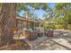 Cozy outdoor patio with comfortable seating, surrounded by lush landscaping and mature trees at 2072 Misty Sunrise Trl, Sarasota, FL 34240