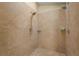 Walk-in shower features multiple shower heads, tile surround, and built-in shelf at 2072 Misty Sunrise Trl, Sarasota, FL 34240