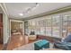 Bright sun room featuring lots of windows and plantation shutters, adjacent to the living room at 2072 Misty Sunrise Trl, Sarasota, FL 34240