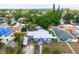 Aerial shot of a blue home with a well-manicured yard in a lush, green neighborhood at 2120 8Th W Ave, Bradenton, FL 34205