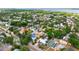 An aerial view shows the home nestled in a neighborhood surrounded by mature trees and water views at 2120 8Th W Ave, Bradenton, FL 34205
