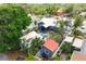 Aerial view displays the home's spacious backyard with a patio, nestled within a leafy neighborhood at 2120 8Th W Ave, Bradenton, FL 34205