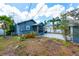 A charming backyard features a screened porch and concrete patio with shade, ideal for outdoor living at 2120 8Th W Ave, Bradenton, FL 34205