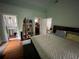 Spacious bedroom with views to the bathroom and closet, hardwood floors, and large windows at 2120 8Th W Ave, Bradenton, FL 34205