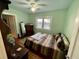 A cozy bedroom with a comfortable bed, a window providing natural light, and a ceiling fan for added comfort at 2120 8Th W Ave, Bradenton, FL 34205