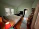 Cozy bedroom with hardwood floors, two windows with blinds, and a door to the outside at 2120 8Th W Ave, Bradenton, FL 34205