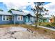 Charming single-story home with a blue exterior, teal door, and metal roof at 2120 8Th W Ave, Bradenton, FL 34205