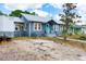 Charming blue home with a vibrant turquoise door and inviting front porch at 2120 8Th W Ave, Bradenton, FL 34205
