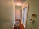 A simple hallway with neutral colored walls and a decorative rug leading to various rooms within the home at 2120 8Th W Ave, Bradenton, FL 34205