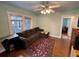 Inviting living room featuring a comfortable brown sectional sofa, decorative rug, and a ceiling fan at 2120 8Th W Ave, Bradenton, FL 34205