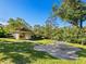 A backyard offers green spaces, shade trees, and a covered seating area at 2155 Wood St # B18, Sarasota, FL 34237