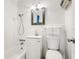 A bright bathroom featuring white tiled walls, a tub and shower, and a simple vanity at 2155 Wood St # B18, Sarasota, FL 34237